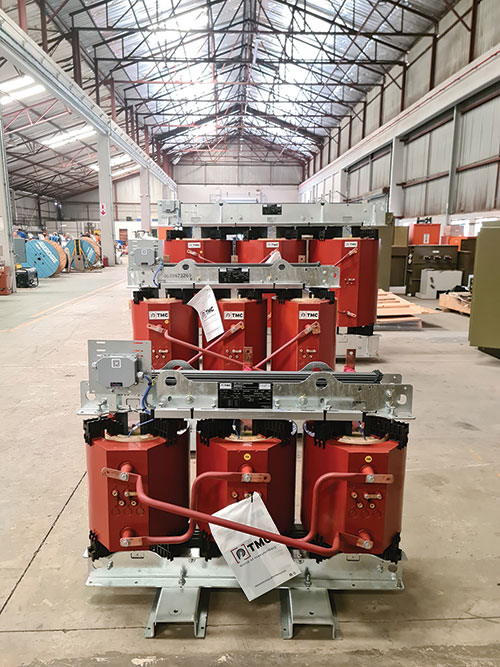 Multiple dry-type transformers in assembly line to be installed in a containerised solution.